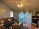 Cozy living room with ceiling fan, fireplace and sliding glass doors that lead to an enclosed sunroom at 550 Bridgeport Dr., Myrtle Beach, SC 29577