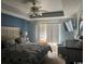 Spacious bedroom with a tray ceiling, a ceiling fan and a large window at 550 Bridgeport Dr., Myrtle Beach, SC 29577