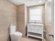 Modern bathroom featuring toilet, sink and vanity, plus tiled walls at 5612 N Kings Hwy., Myrtle Beach, SC 29577