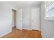 Bedroom with hardwood floors, showing doorway to another room and a closet at 5612 N Kings Hwy., Myrtle Beach, SC 29577