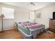 Bedroom featuring hardwood floors, ceiling fan, and a bright, airy feel from multiple windows at 5612 N Kings Hwy., Myrtle Beach, SC 29577