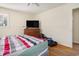 Bright bedroom featuring wood dresser, television, and doorway to another room at 5612 N Kings Hwy., Myrtle Beach, SC 29577