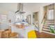 Bright kitchen with white cabinets, stainless steel appliances, island seating and stairwell access at 5612 N Kings Hwy., Myrtle Beach, SC 29577