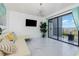 Bright living area featuring a TV, decor, and access to the balcony at 5905 S Kings Hwy. # 344B, Myrtle Beach, SC 29575