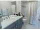 Bathroom with stylish gray vanity, tub-shower combo, and modern fixtures, offering a spa-like experience at 616 Edgecreek Dr., Myrtle Beach, SC 29579