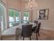 Bright breakfast nook features a view of the pool and yard with decorative chandelier and accent painting at 616 Edgecreek Dr., Myrtle Beach, SC 29579