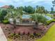 Beautiful entrance to The Bluffs on the Waterway, surrounded by lush landscaping and palm trees at 616 Edgecreek Dr., Myrtle Beach, SC 29579