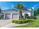 Charming two-story home with a well-manicured lawn, complemented by a beautiful palm tree and a two car garage at 616 Edgecreek Dr., Myrtle Beach, SC 29579