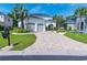 Elegant home featuring a brick driveway, meticulously landscaped yard, and a charming two-car garage at 616 Edgecreek Dr., Myrtle Beach, SC 29579