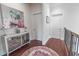 Bright upstairs hallway featuring hardwood floors, a stylish rug, and elegant accent furniture at 616 Edgecreek Dr., Myrtle Beach, SC 29579