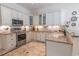 Well-equipped kitchen with granite countertops, stainless steel appliances, and custom cabinetry at 616 Edgecreek Dr., Myrtle Beach, SC 29579