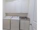 Functional laundry room with washer, dryer, utility sink, and ample storage cabinets for convenience at 616 Edgecreek Dr., Myrtle Beach, SC 29579