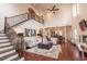 Spacious living room with high ceilings, large windows, a fireplace, and elegant staircase at 616 Edgecreek Dr., Myrtle Beach, SC 29579