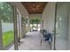 Covered patio with fan featuring tile floors and plenty of natural light overlooking the yard at 616 Edgecreek Dr., Myrtle Beach, SC 29579