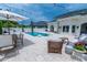 Inviting backyard pool area with stylish lounge furniture and well-manicured landscaping offers a relaxing outdoor oasis at 616 Edgecreek Dr., Myrtle Beach, SC 29579