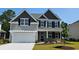 Charming two-story home with stone accents, neutral siding, a two-car garage, and manicured landscaping at 720 Rupert Dr, Conway, SC 29526