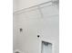 Bright laundry room features white walls with connections and an overhead wire rack for storage at 723 Chazen Way, Longs, SC 29568