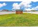 Spacious backyard with a wooden shed and white pergola, perfect for outdoor activities at 732 American Beech St., Loris, SC 29569