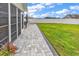 Manicured backyard featuring a stone patio, an umbrella, and a privacy fence at 732 American Beech St., Loris, SC 29569