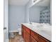 Modern bathroom featuring light blue walls, a double sink vanity, and a large mirror at 732 American Beech St., Loris, SC 29569