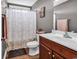 Bathroom featuring wood floors, gray walls, a floral shower curtain, and a dark vanity at 732 American Beech St., Loris, SC 29569