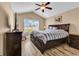 Bedroom featuring light wood floors, a window, a ceiling fan, and a dark wood bed frame at 732 American Beech St., Loris, SC 29569