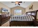 Bedroom featuring light wood floors, a window, a ceiling fan, and a dark wood bed frame at 732 American Beech St., Loris, SC 29569