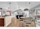 Bright dining area connects the kitchen and living spaces in this open-concept home with vaulted ceilings at 732 American Beech St., Loris, SC 29569