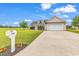 Charming single-Gathering home with a well-manicured lawn, a long driveway, and a two-car garage at 732 American Beech St., Loris, SC 29569
