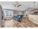 Inviting living room features wood-look tile flooring and open floor plan to the dining and kitchen area at 732 American Beech St., Loris, SC 29569