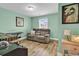 Cozy living room with light green walls, hardwood floors, and a comfortable gray couch under a window at 732 American Beech St., Loris, SC 29569