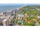 An expansive aerial view featuring coastal buildings and lush greenery against the backdrop of the ocean at 7403 N Ocean Blvd. # C, Myrtle Beach, SC 29572