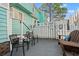 Cozy back patio with outdoor seating, and a white fence decorated with beach-themed signs at 7403 N Ocean Blvd. # C, Myrtle Beach, SC 29572
