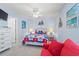 Bright bedroom decorated with coastal accents, featuring a charming red couch and nautical bedding at 7403 N Ocean Blvd. # C, Myrtle Beach, SC 29572