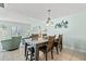 Open-concept dining area with seating for six, stylish lighting, and seamless connection to the living room at 7403 N Ocean Blvd. # C, Myrtle Beach, SC 29572