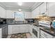 Well-lit kitchen features white cabinetry, modern appliances, and a stylish backsplash at 7403 N Ocean Blvd. # C, Myrtle Beach, SC 29572
