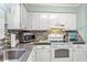 Kitchen includes white cabinets, tiled backsplash, and modern oven at 7403 N Ocean Blvd. # C, Myrtle Beach, SC 29572