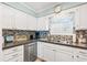 Bright kitchen with white cabinets, stainless steel appliances, and a double sink at 7403 N Ocean Blvd. # C, Myrtle Beach, SC 29572