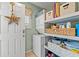 Efficient laundry room with stacked washer and dryer unit and convenient shelving at 7403 N Ocean Blvd. # C, Myrtle Beach, SC 29572