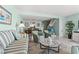 Bright living room features neutral tile floors, comfortable seating arrangement, and open access to the dining area at 7403 N Ocean Blvd. # C, Myrtle Beach, SC 29572