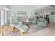 Inviting living room featuring tile flooring, a comfortable seating arrangement and access to the dining area at 7403 N Ocean Blvd. # C, Myrtle Beach, SC 29572