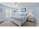 Bright main bedroom with a queen bed, ceiling fan, and coastal decor at 7403 N Ocean Blvd. # C, Myrtle Beach, SC 29572