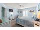 Coastal-themed main bedroom includes a bed, ceiling fan, and white furniture at 7403 N Ocean Blvd. # C, Myrtle Beach, SC 29572