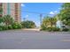 Scenic street view of North Shore Oceanfront Hotel lined with lush landscaping and tall buildings at 7403 N Ocean Blvd. # C, Myrtle Beach, SC 29572