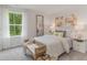 Bedroom with a large window, bench at the foot of the bed, and modern decor at 7431 Meadow Walk Loop, Loris, SC 29569