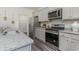 Well-equipped kitchen with gray cabinets, stainless steel appliances, and granite countertops at 7431 Meadow Walk Loop, Loris, SC 29569
