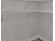 Unfinished walk-in closet with white wire shelving and gray floors at 7431 Meadow Walk Loop, Loris, SC 29569