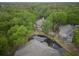 Scenic aerial view of a complex surrounded by lush greenery and a serene pond with water features at 802 Colony Pl. # 2E, Calabash, NC 28468
