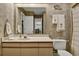 Bathroom featuring wallpaper, sink, and a mirror with lighting at 802 Colony Pl. # 2E, Calabash, NC 28468