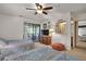 Bright bedroom with two twin beds, dresser with TV, and screened-in porch access at 802 Colony Pl. # 2E, Calabash, NC 28468